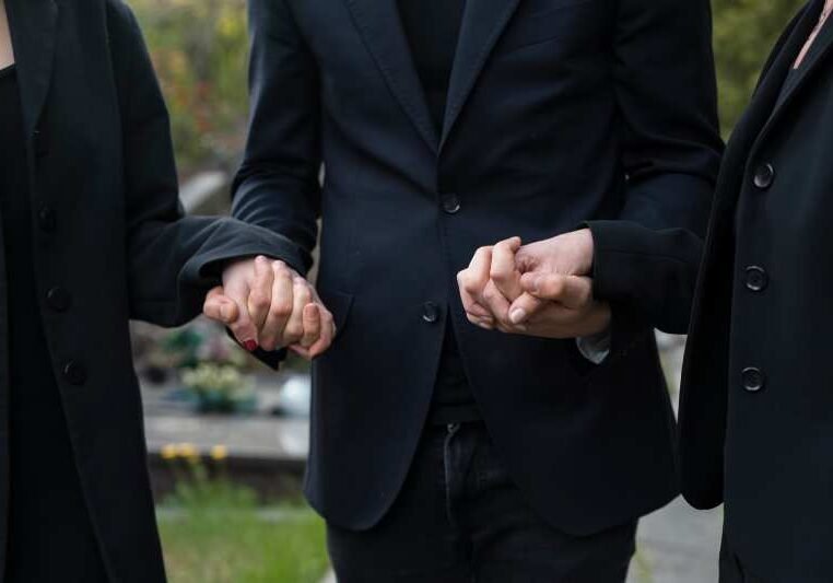 Mourning family together at the cemetery